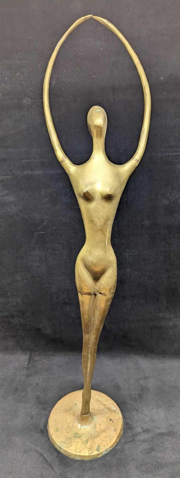 Vintage Art Deco Brass Female Sculpture: Vintage Art Deco Brass Female Sculpture. Made of hollow brass. This is approx 7 1/2" x 6" x 33" and it weighs 5.10 lbs. The sculpture has some surface tarnish, scratches, and a chip on a b