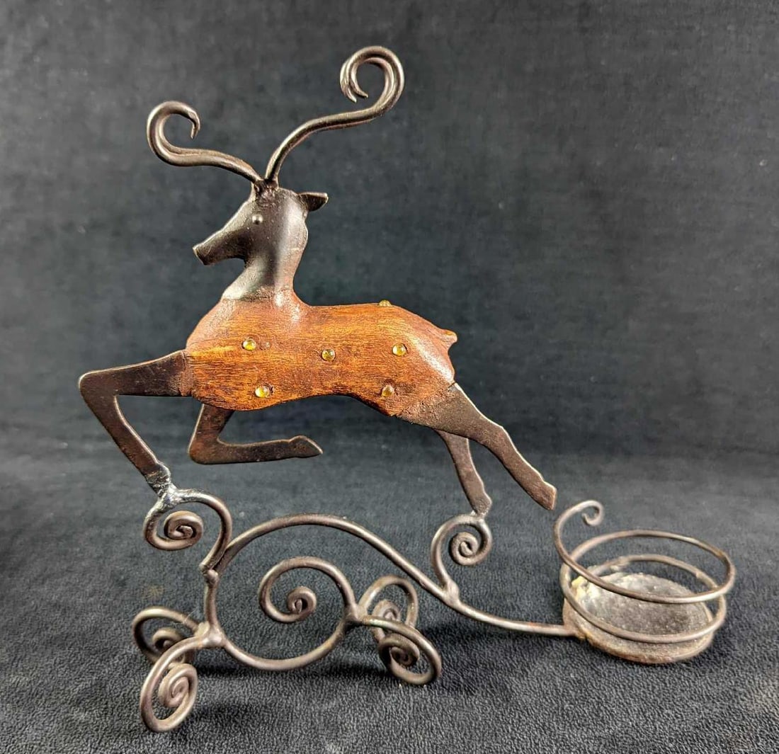 Magic Reindeer Christmas Inspired Tea Light Holder: This metal tealight holder is cute and festive for the Holidays. This tealight candle holder is in good condition lightly used. It has some was residue where the candle would sit. Is approx 9" x 3