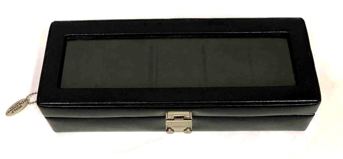 Genuine Leather Watch Display Case By Wolf Designs Since 1834: This lot contains a genuine leather watch display case by Wolf Designs Since 1834. It is approx 11 1/2" x 4" x 3" and weighs about 1.5lbs. Overall the display case is in good used conditio