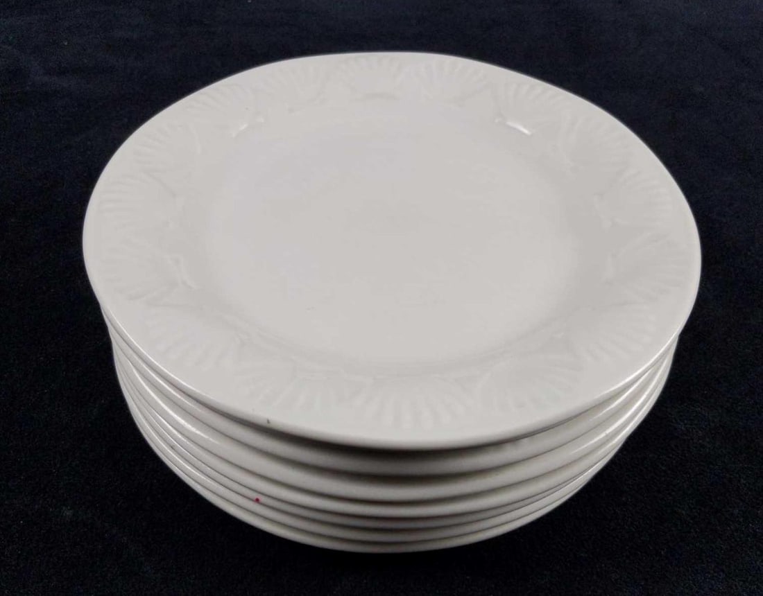 Gibson Designs Shell Salad Plates Set Of Eight: Here are eight white embossed seashell China salad plates by Gibson Designs. Plates have a textured seashell pattern at the rims. This design was retired bt Gibson Designs. Plates are approx 8" ac