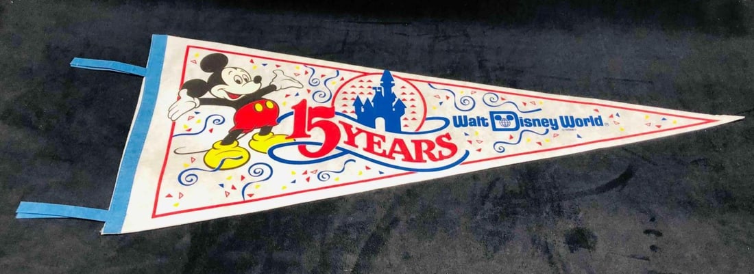 15 Years Walt Disney World Pennant Flag: This lot contains a 15 Years Walt Disney World Flag. It is approx 11 3/4" x 34" and it weighs about 0.05lbs. Overall the Flag is in good used condition with some light wear from use over time.