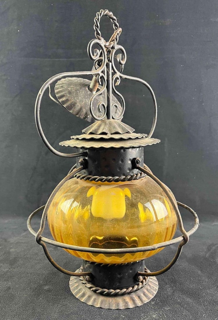 Vintage Amber Glass Globe Lamp: Vintage Amber Glass Globe Lamp This vintage lamp ias made from beautiful amber glass encased in metal. This is made bas a ceiling lamp and has a small part on top to hang and connect wiring. The lamp 