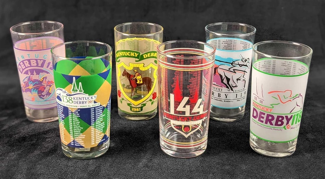 Six Kentucky Derby Mint Julep Drinking Glasses: This lot includes: (1) Kentucky Derby 107. May 2, 1981. Has light wear due to storage and age. (1) Kentucky Derby 118. May 2, 1992. (1) Kentucky Derby 119. May 1, 1993. (1) Kentucky Derby 120. May 7, 