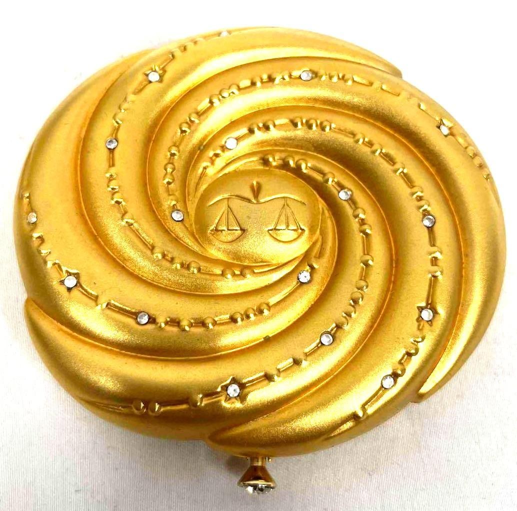 Vintage EstÄ“e Lauder Golden Colored Libra Compact: This lot contains a Vintage EstÄ“e Lauder Golden Colored Libra Compact. It is approx 3" x 3" and it weighs about 0.3lbs. Overall the EstÄ“e Lauder Libra Compact is in good condition with