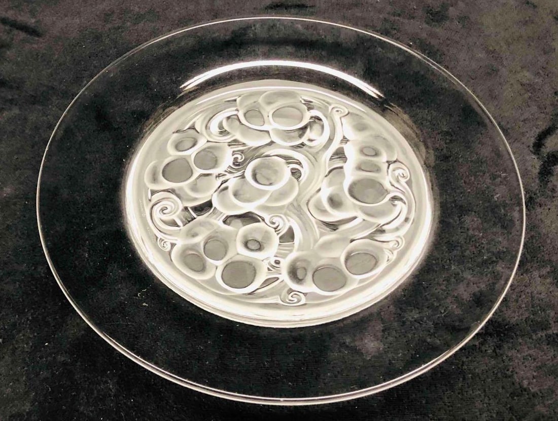 Signed Lalique Marienthal Luncheon Plate: This lot contains a Signed Lalique Marienthal Luncheon Plate. It is approx 9 1/4" x 9 1/4" x 1" and it weighs about 1.8lbs. Overall the Lalique plate is in good used condition with some li