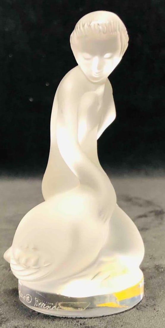 Lalique Signed Crystal Leda And The Swan: This lot contains a Lalique Signed Crystal Leda And The Swan. It is approx 2 1/2" x 2" x 4 1/2" and it weighs about 0.7lbs. Overall the Lalique figurine is in good used condition with some