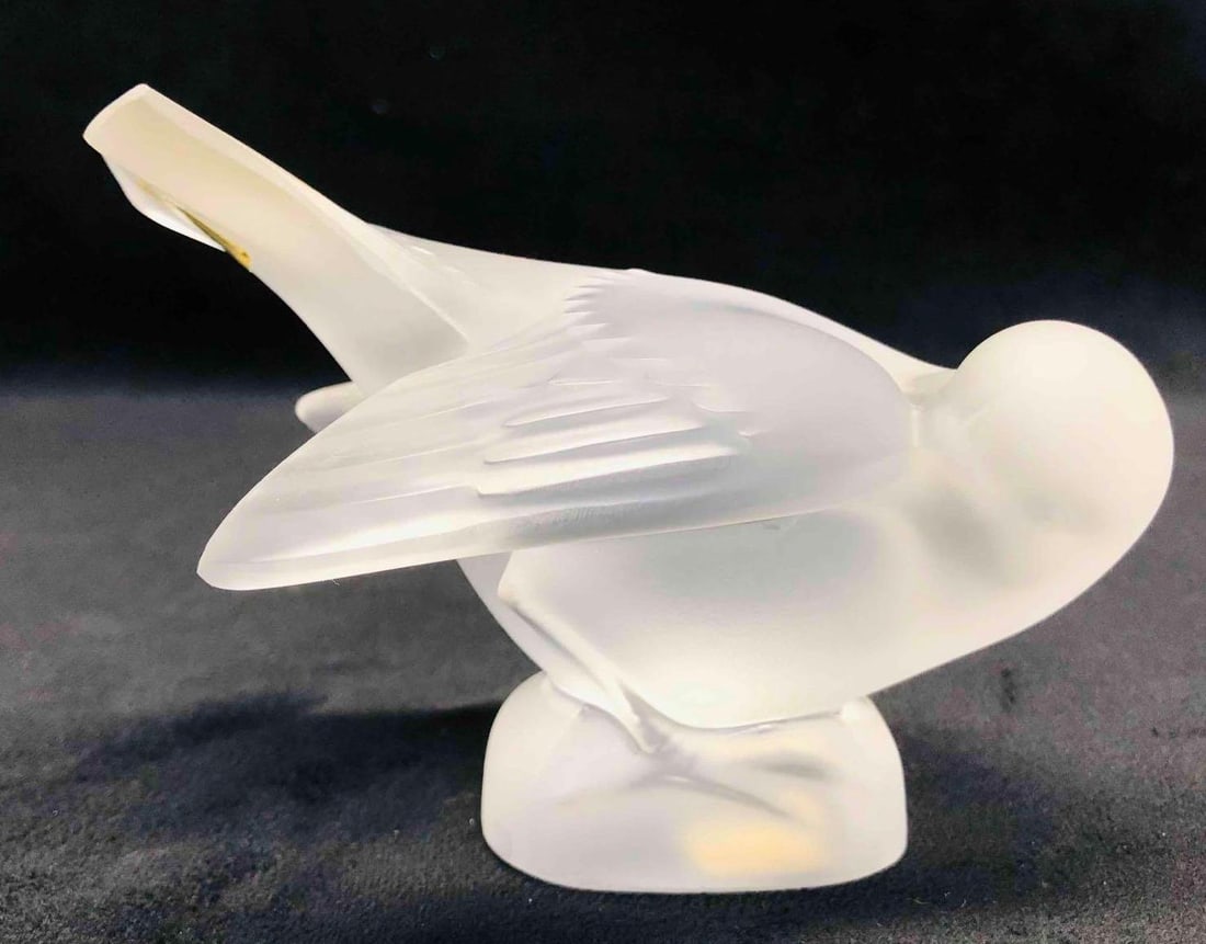 Signed Lalique Sparrow Head Under Wing: This lot contains a Signed Lalique Sparrow Head Under Wing. It is approx 4 3/4" x 1 1/2" x 3 1/4" and it weighs about 1lbs. Overall the Lalique sparrow is in good used condition with some 