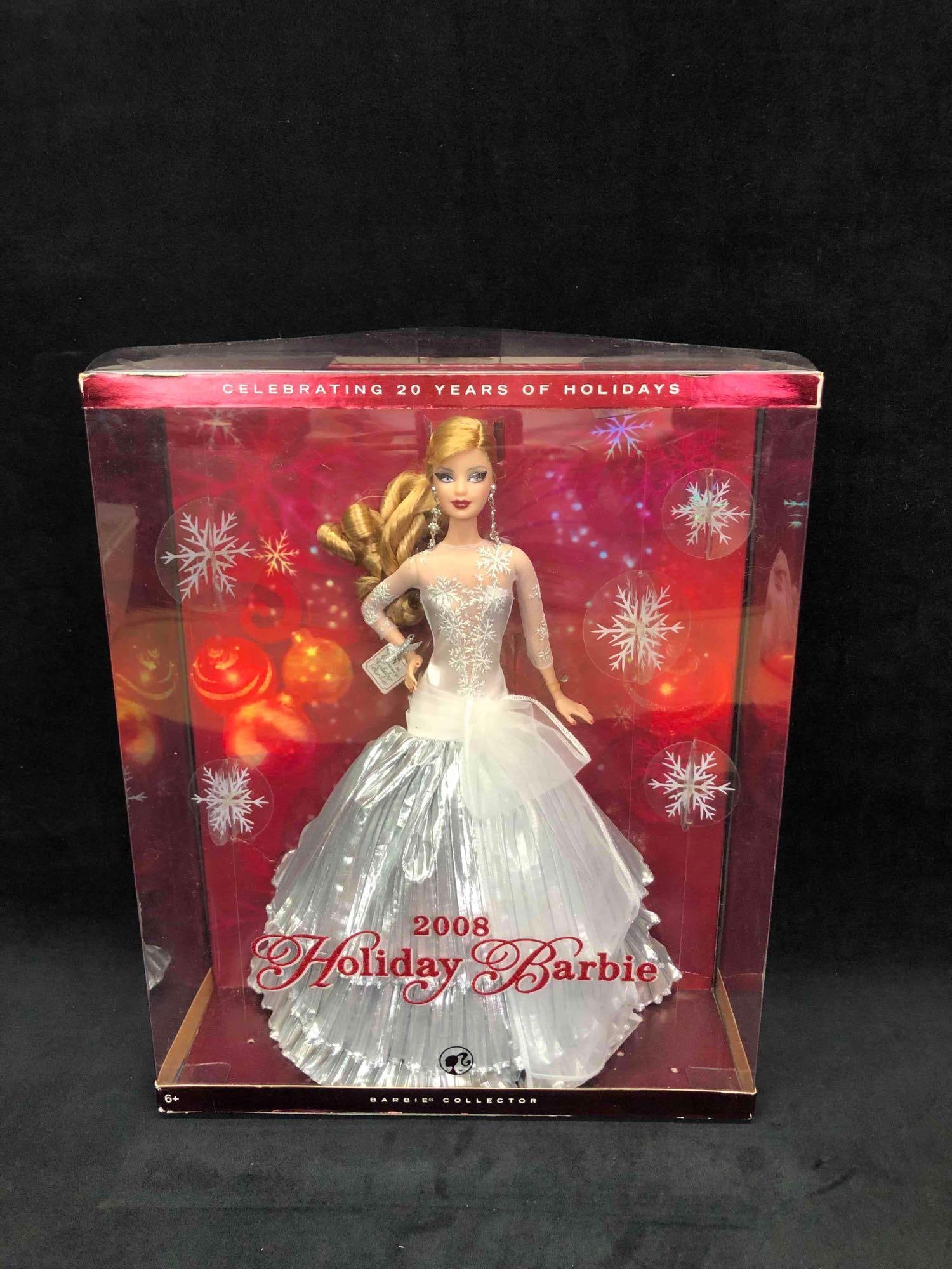 2008 Holiday Barbie: This lot contains a 2008 holiday Barbie from the Barbie Collector. This Barbie comes in her original packaging and has never been opened. Accessories include her earrings, shoes, dress and stand. The 
