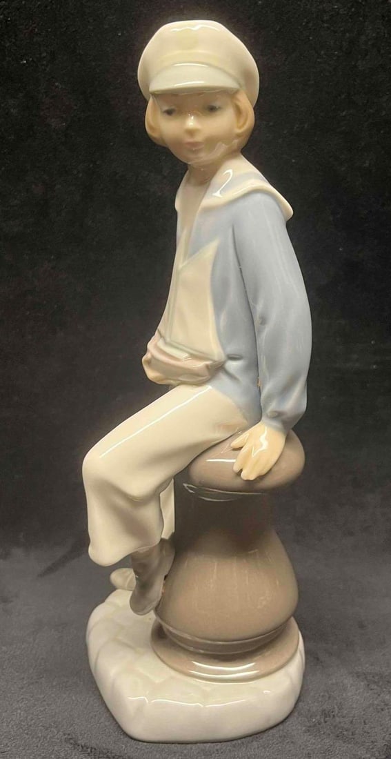 LladrÃ³ Boy With Yacht 4810: This lot contains a LladrÃ³ Mechanic Boy 4897. Handmade In Spain. Designed in 1972. It is approx 4" x 3" x 9" and it weighs about 1lb. Retired in 1998. Overall the LladrÃ³ is in good u