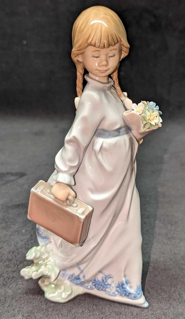 Retired Lladro School Days Young Girl Figurine: Retired Lladro School Days Young Girl Figurine. This was designed by Antonio Ramos and was released from the year 1988 to 1992. The figurine is approx 4" x 4" x 8 1/4" and it weighs 0.87lb