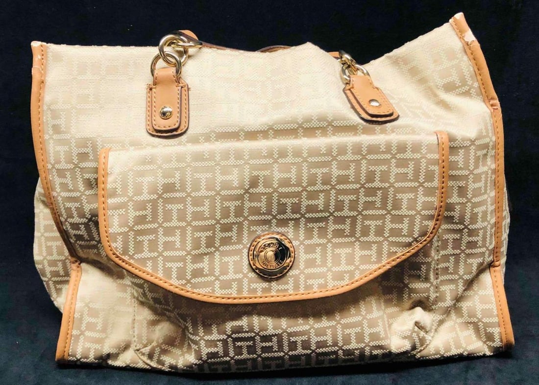 Large Tommy Hilfiger Tote: This lot contains Large Tommy Hilfiger Tote. Made in China. Trim is made of Imitation Leather. It is approx 14 1/2" x 6 3/4" x 19" and it weighs about 1.6lbs. Overall the Tommy Tote is in 