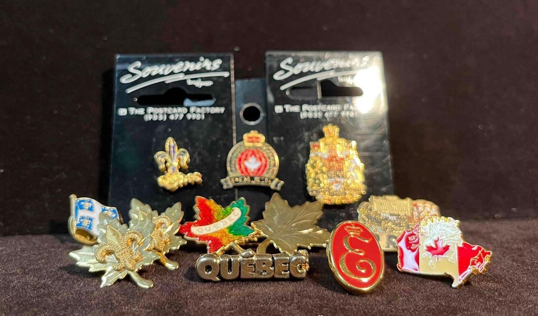 Bundle Of Canada Enamel Pins (F18): This lot contains a Bundle Of Canada Enamel Pins (F18).The pins fit together in a small 6 3/4" x 4" plastic bag and altogether they weigh about 1.5oz. Overall the pins are in good used conditi