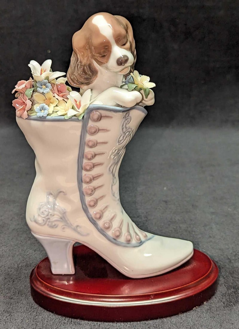 Retired Lladro A Well Heeled Puppy Figurine: Retired Lladro A Well Heeled Puppy Figurine. This was designed by Francisco Polope and was released from the year 2001 to the year 2005. This is approximately 6" x 3" x 8 1/2" and it weigh