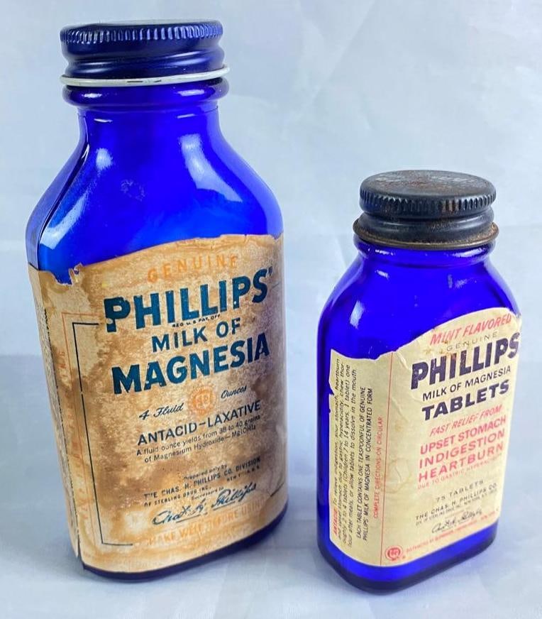 Two 1950s Phillips Milk of Magnesia Bottles: Two 1950s Phillips Milk of Magnesia Bottles Pair of Phillips milk of magnesia bottles from the late 1950s, with intact labels and caps. Bottles have some wear on the labels, but no known chips or crac