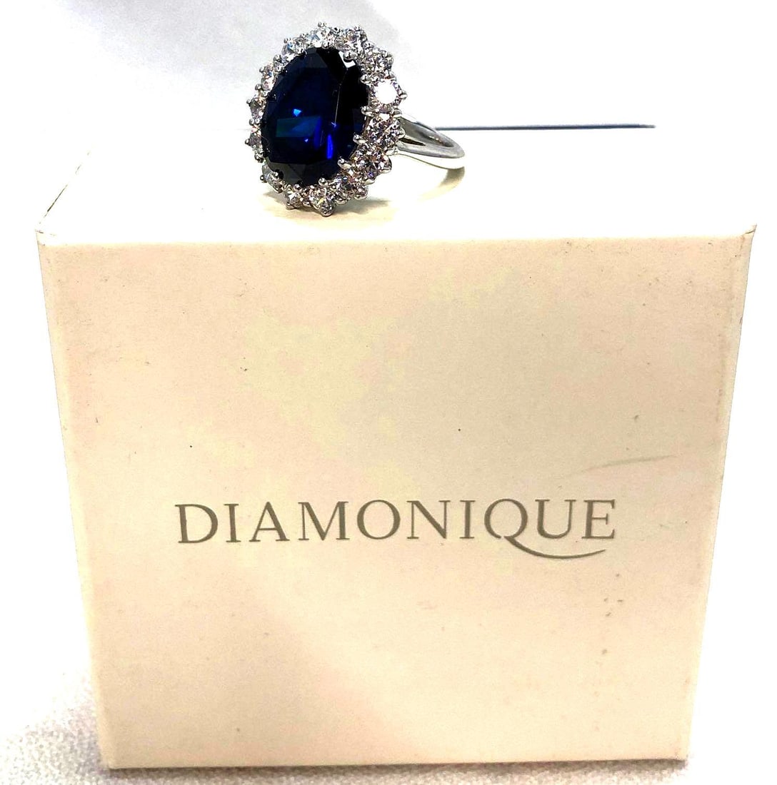 Diamonique Sterling 8.8 ct tw Simulated Sapphire Ring: Diamonique 925 Sterling 8.8 ct tw Simulated Sapphire and CZ Halo Ring in original box. It measures approximately 2-3/4" x 2-3/4" x 1-1/2" and it weighs 0.1lbs. The Simulated Sapphire Ring