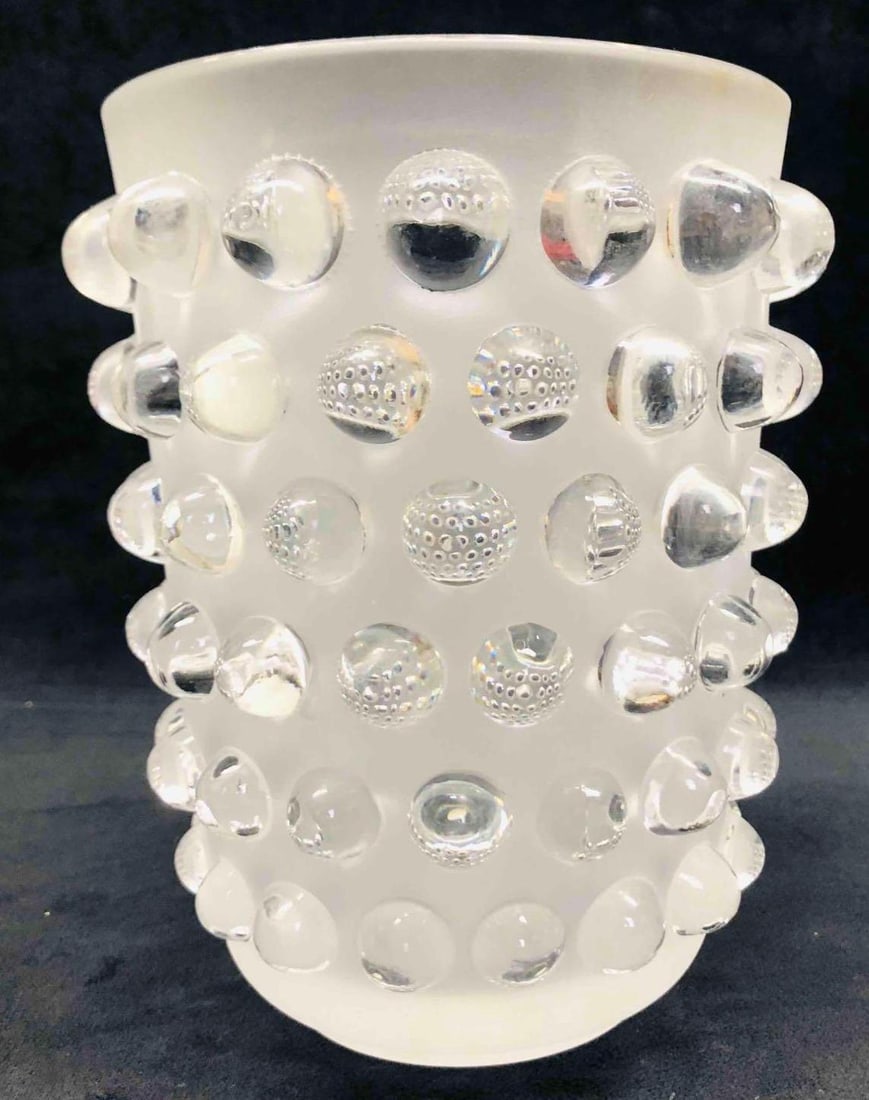 Lalique Signed Mossi Vase: This lot contains a Lalique Signed Mossi Vase. It is approx 6 1/4" x 6 1/4" x 8 1/4" and it weighs about 6.8lbs. Overall the Lalique vase is in good used condition with some light wear fro