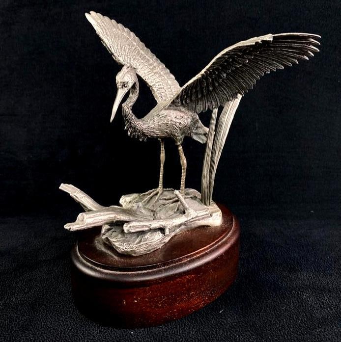 Irving Burgues Pewter Crane on Wood Base: Irving Burgues Pewter Crane on Wood Base Signed fine pewter statue by Irving Burgues on a dark stained wood base. From 1975, this is an exquisite 6.5" statue with incredible detail. Approximate si