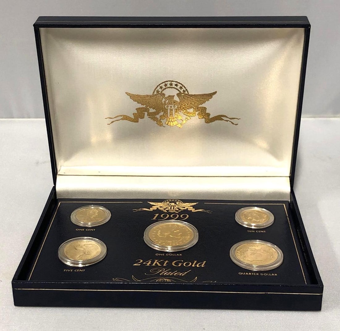24Kt Gold Plated Coin Sets - 1999 & 2000 (428B): Two 24 Kt Gold Plated Coin Sets in Keepsake Boxes - 1999 and 2000. Each Coin Set measures approximately 6-1/4" x 4-1/2" x 1-1/4" and their combined weight is about 0.9lbs. The 24 Kt Gold P