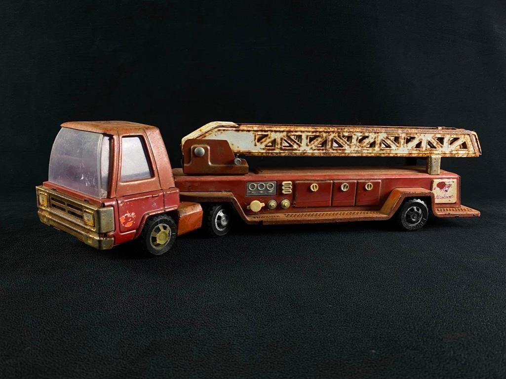 Antique Metal Firetruck Hook & Ladder Toy: Antique Metal Firetruck Hook & Ladder Toy Metal fire engine hook & ladder toy from the 1960s or 1970s, made in Japan. The ladder still extends and swivels. The paint is in pretty good shape f