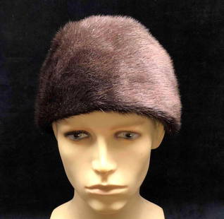 Extra Luxus Fur Beaver Hat: This lot contains an Extra Luxus fur beaver hat. The interior is a gray/tan silk like material. The tag is on the inside and has begun to separate from the interior. The hat is approx 9" x 9"