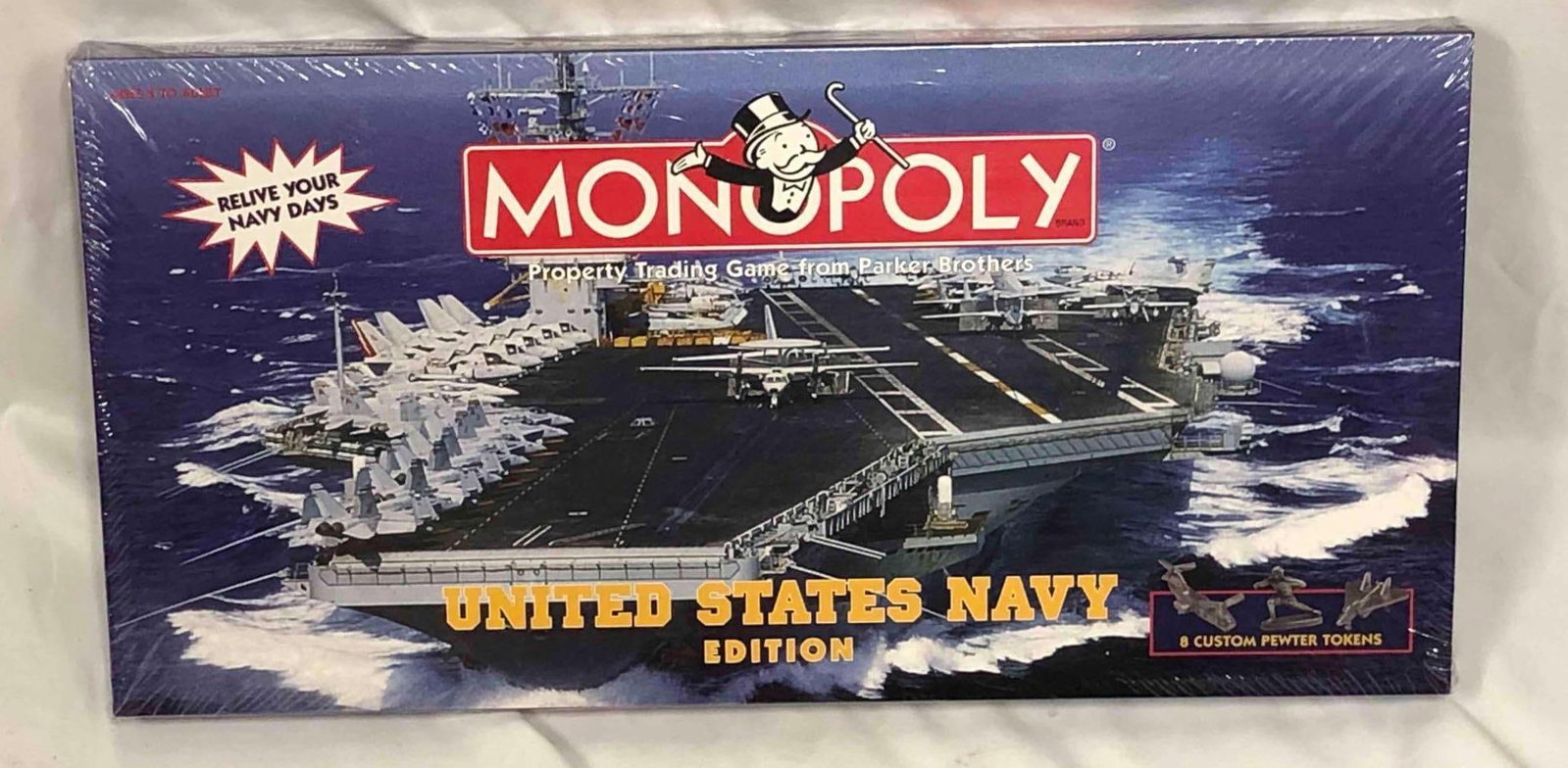 United States Navy Edition of Monopoly: This lot contains the United States Navy Edition of Monopoly. It is approx 10" x 20" x 1-1/2" and it weighs about 2.27lbs. Overall the board game is in new condition with original shrink w