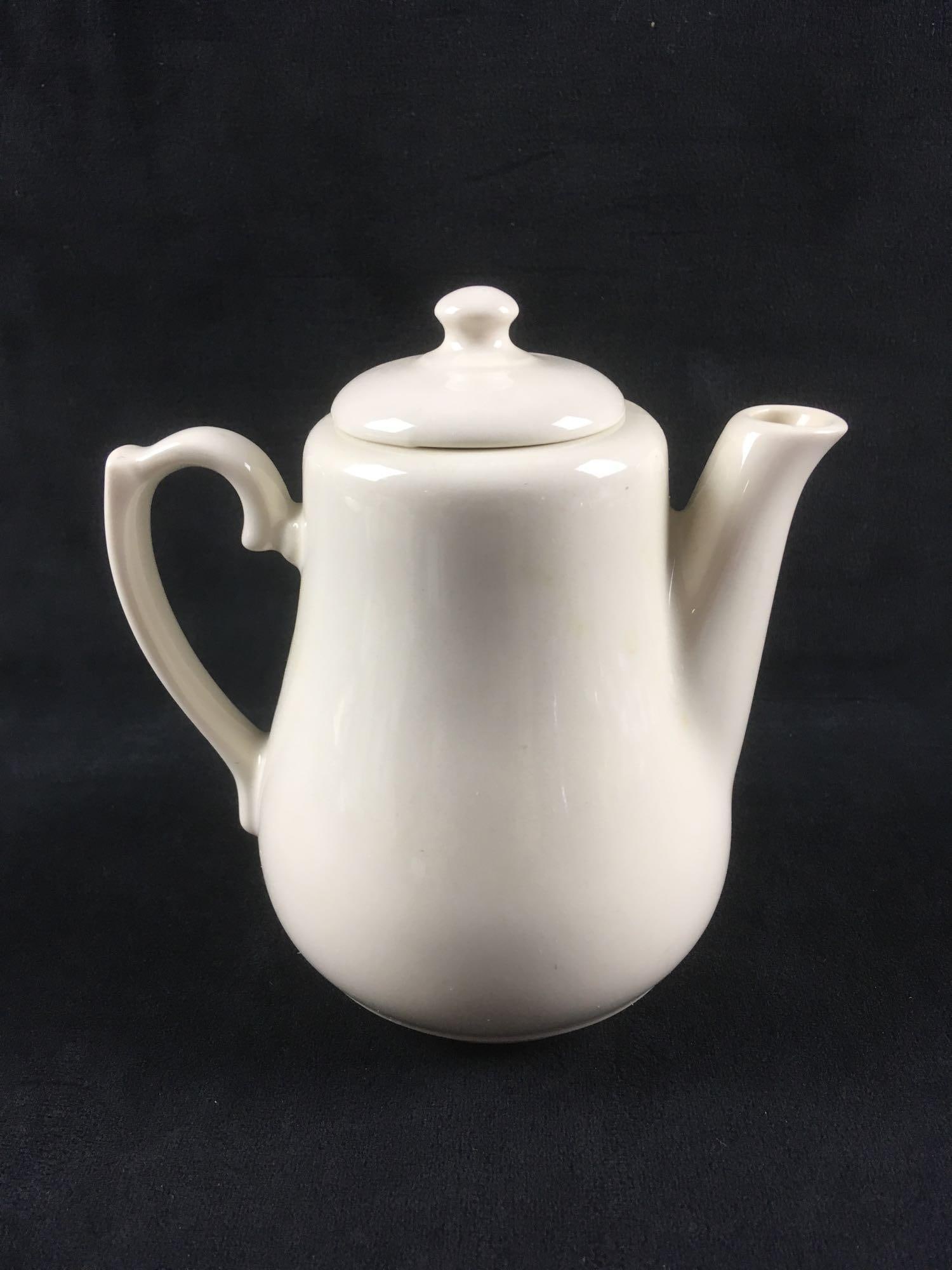 Vintage HLC Teapot: Vintage HLC Teapot. This teapot is in great condition. There are no chips or cracks in the porcelain. Teapot is ivory colored and has an HLC mark on the bottom. The teapot measures 5.5" H x 3"