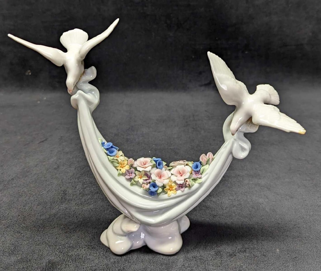 Lladro Petals Of Peace Doves & Flowers Figurine: Lladro Petals Of Peace Doves & Flowers Figurine. This was designed by Antonio Ramos and was originally released in the year 1998. This is approximately 9 1/4" x 3" x 7 3/4" and it weig