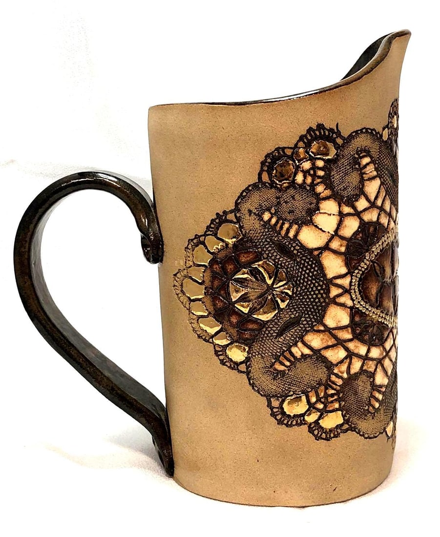 VTG 1981 Handcrafted Stoneware Pitcher 24K Gold: Vintage 1981 Handcrafted Stoneware Pitcher with 24K Gold Appliques and Delicate Textures by Jo Ann Wedge. Artist mark on bottom and original tag included. It is approx 7-3/4" x 7" x 4" and