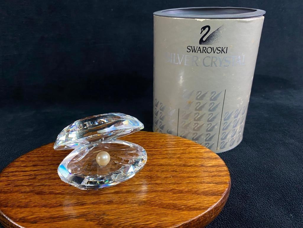 Swarovski Oyster Figurine: Swarovski Oyster Figurine. Crystal oyster figurine by Swarovski. Features a faceted crystal oyster, with an imitation pearl. This adorable figurine adds a classy and whimsical touch to any shelf, desk