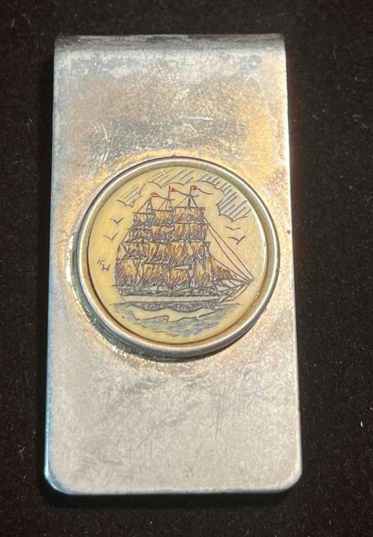 Vintage Signed Scrimshaw Ship Brass Money Clip (F18): This lot contains a Vintage Signed Scrimshaw Ship Brass Money Clip (F18). Signature reads K W on the left side. It is approx 2" x 1" x 1/4" and it weighs about 0.03lbs. Overall the Vintage