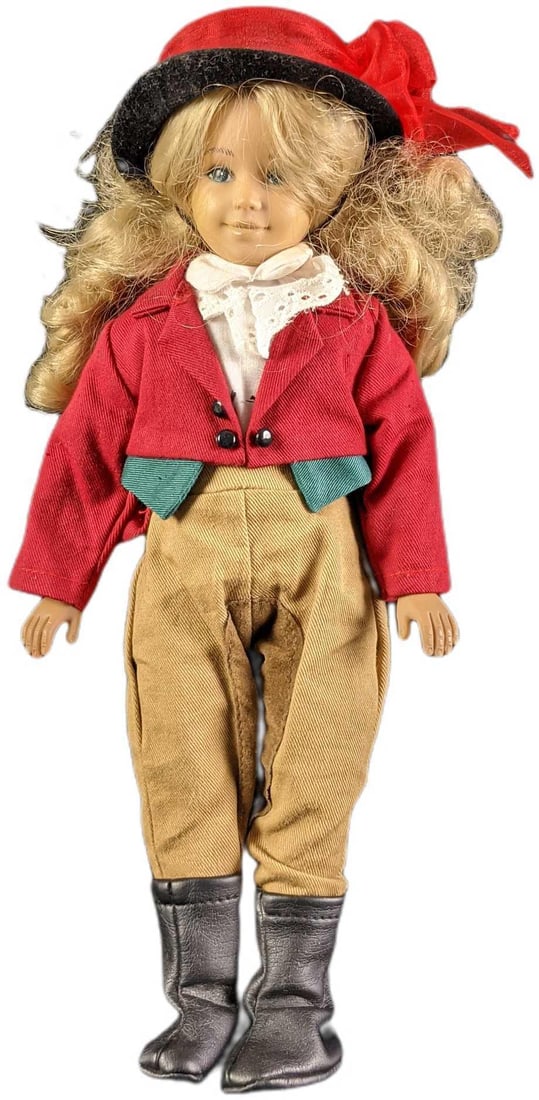 1995 Horse Rider Girl Doll by Unimax Toys LTD: Horse Rider Girl Doll. Manufactured in 1995 by Unimax Toys. Made from vinyl. She is wearing horse rider attire that includes the following; a red coat, breeches, black boots, hat, and undershirt. The 