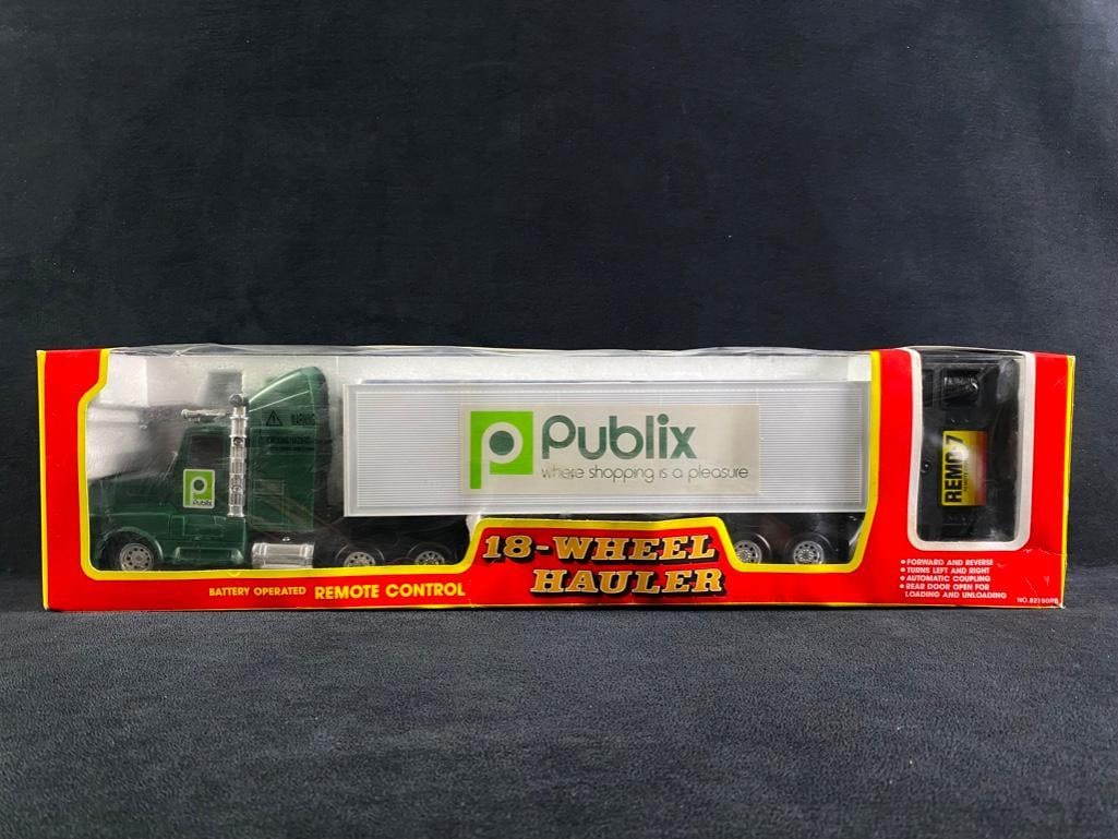 Publix Battery Operated Remote Control 18-Wheeler: Publix Battery Operated Remote Control 18-Wheeler. Still in its original box. Forward and reverse! Turns left and right! Automatic coupling! The rear door is open for loading and unloading. Comes with