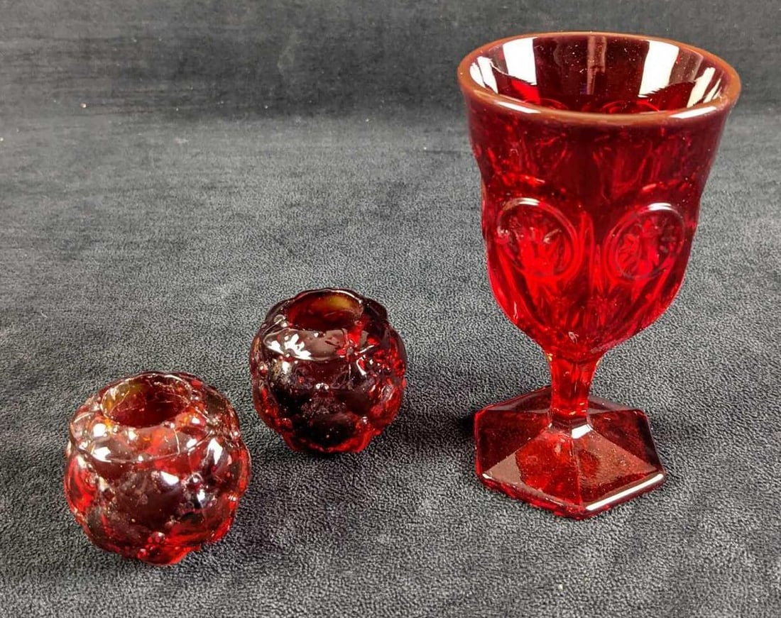 Vintage Retired Fostoria Ruby Coin Wine Glass And Candle Holders: This lot includes: (1) Vintage Retired Fostoria Ruby Coin Wine Glass. This is approx 2 3/4" x 2 3/4" x 5". Is in a good, vintage condition with no known damage. (2) Ruby Candle Holders. T