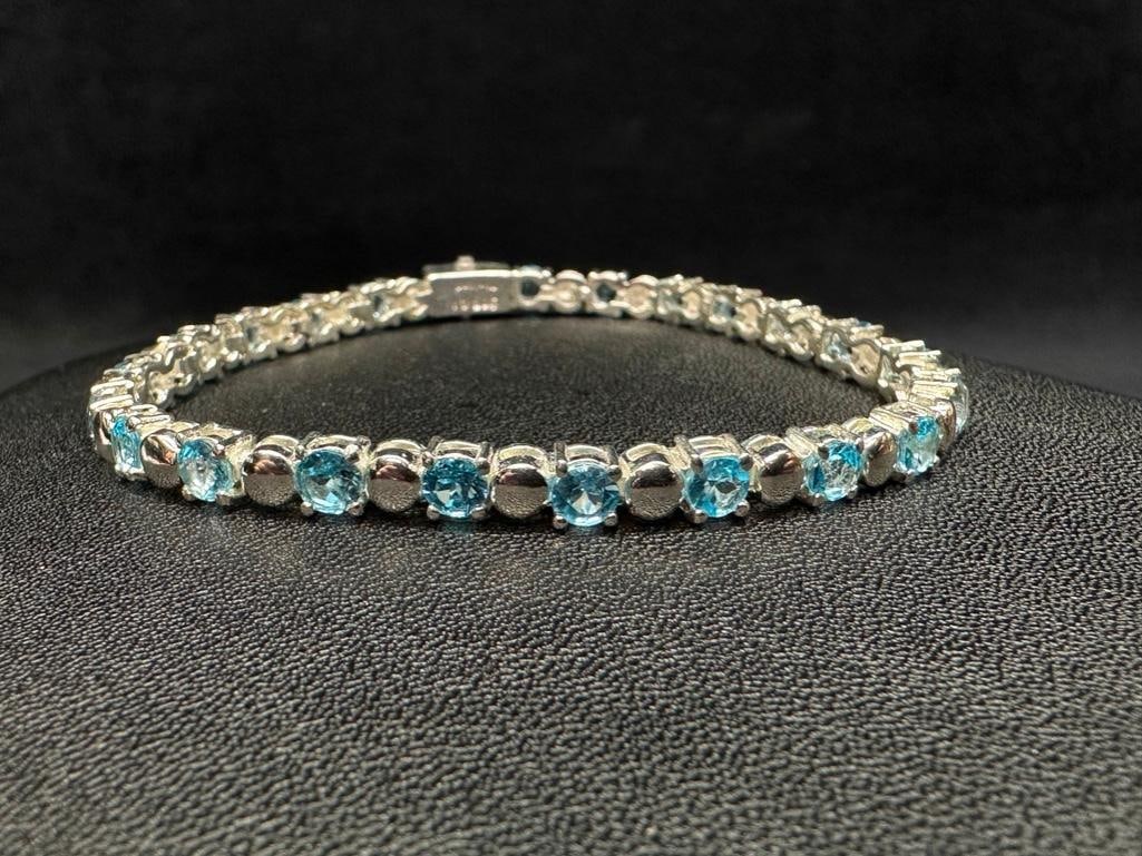 Sterling Sky Blue Topaz Tennis Bracelet: This piece of jewelry has been tested and researched prior to listing. Please view all our pictures they are part of our description. DETAILS: Metal - Sterling Silver Color - Silver Stones - none Hall