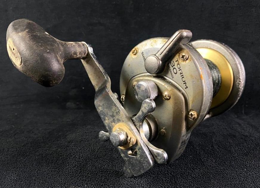 Shimano Torium 30 Fishing Reel: Shimano Torium 30 Fishing Reel Torium 30 star-drag saltwater reel by Shimano. Currently in working condition, with some wear and light salt corrosion in places. Is designed for minimum flex, to maxim
