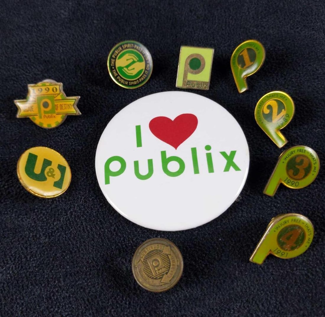 Ten Vintage Employee Only Publix Supermarket Pins: This lot consists of ten Publix Supermarket employee-only pins. Starting with: (1) I Heart Publix Badge. (1) 1990 - Decade Of Destiny Pin. (1) U&I Pin. This was handed out in 1989
