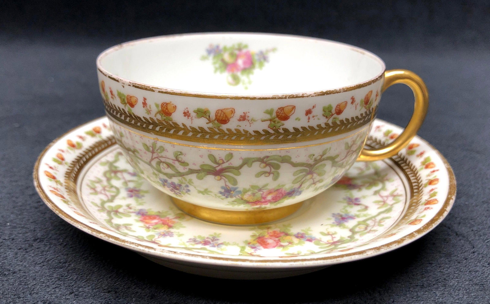 Antique J. Pouyat Limoges (J P L) - Made in France - Tea Cup and Saucer: Antique Jean Pouyat Limoges - Made in France - Tea Cup with Handles and Saucer - Pink, Yellow, Blue, Purple Flowers, Green Vines and Acorns. Tea Cup 4-1/4" x 3-1/2" x 2" Saucer 5-1/4" 