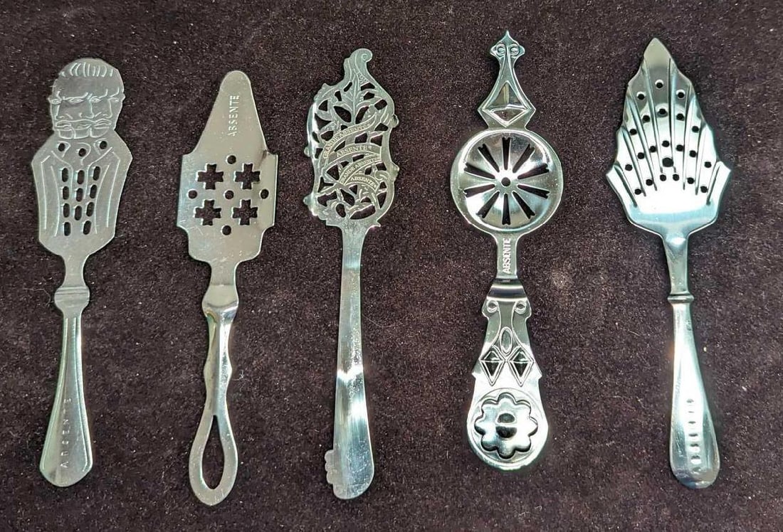 5 Metal Absinthe Strainer Spoons I: 5 Metal Absinthe Strainer Spoons I. This lot includes: (1) Vincent Van Gogh Seeing Double Absinthe Strainer Spoon. This is approx 1 1/2" x 6 1/4". (1) Absinthe Spoon. This metal spoon is appro