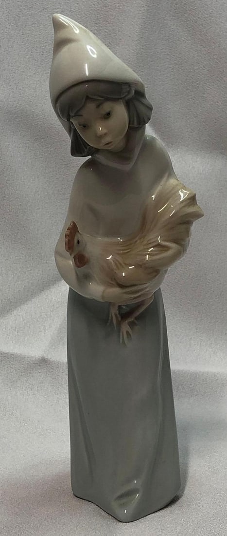 1970 Lladro 4677 Shepherdess With Rooster: This lot contains a 1970 Lladró 4677 Shepherdess With Rooster. Retired in 2002. Handmade in Spain. It is approx 7-3/4" x 2" x 2-1/4" and it weighs about 0.5lbs. Overall the Lladró is in 