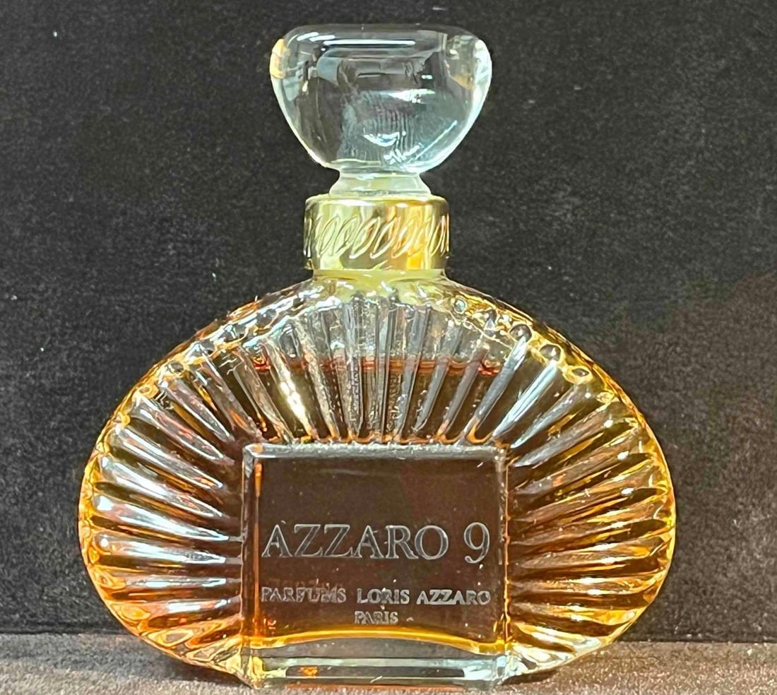 Azzaro 9 By Loris Azzaro Parfum: This lot contains a Azzaro 9 By Loris Azzaro Parfum. It is approx 2 1/2" x 3/4" x 2 3/4" and it weighs about 2.2oz. Overall vintage perfume bottle is in good used condition with some norma