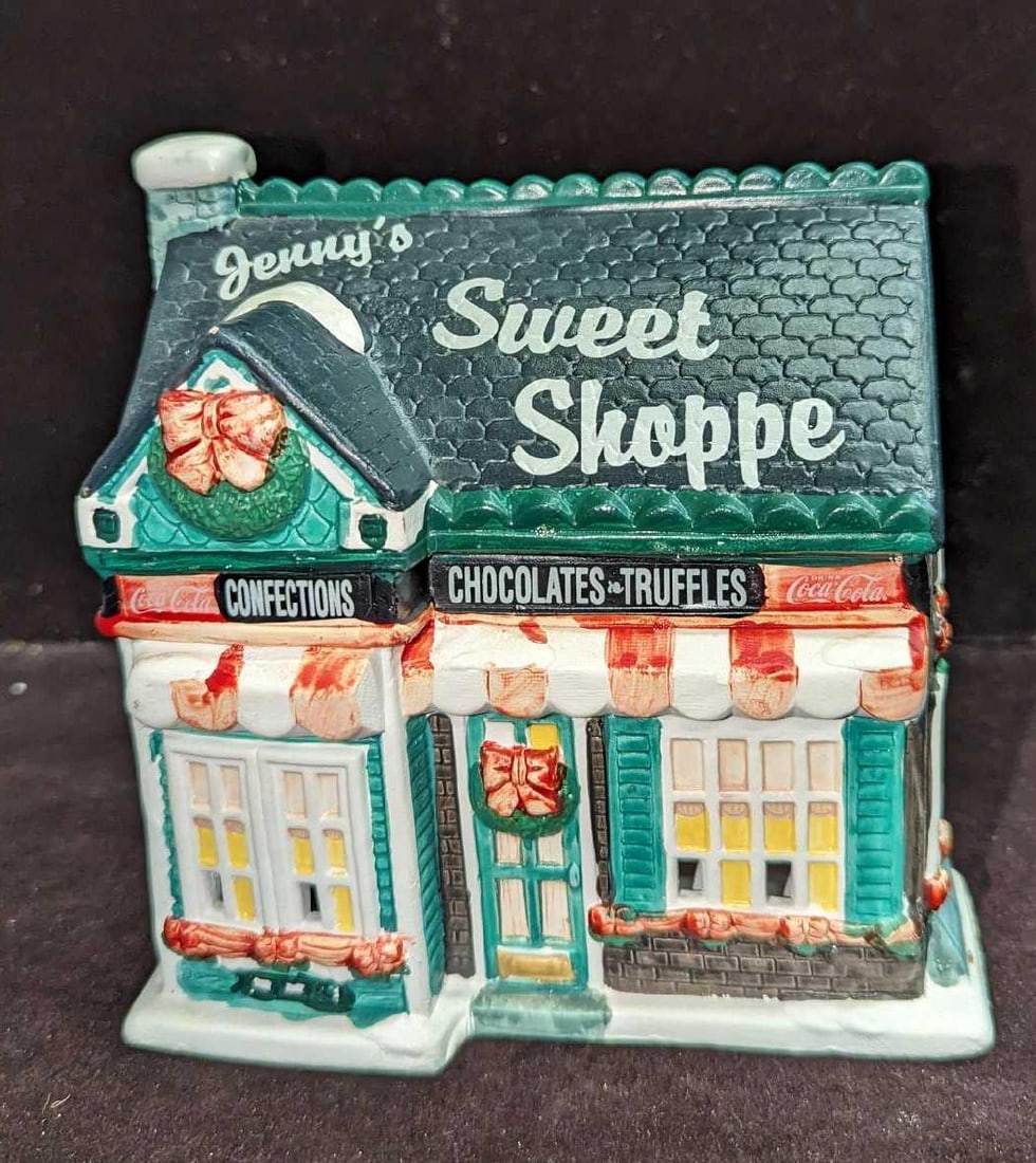 Coca-Cola Lighted Town Square Jenny's Sweet Shoppe: Coca-Cola Lighted Town Square Jenny's Sweet Shoppe. Comes in the original box that is approx 9" x 5 3/4" x 7 1/4" and it weighs 1.86lb. Made of a ceramic. The lighting fixture was test
