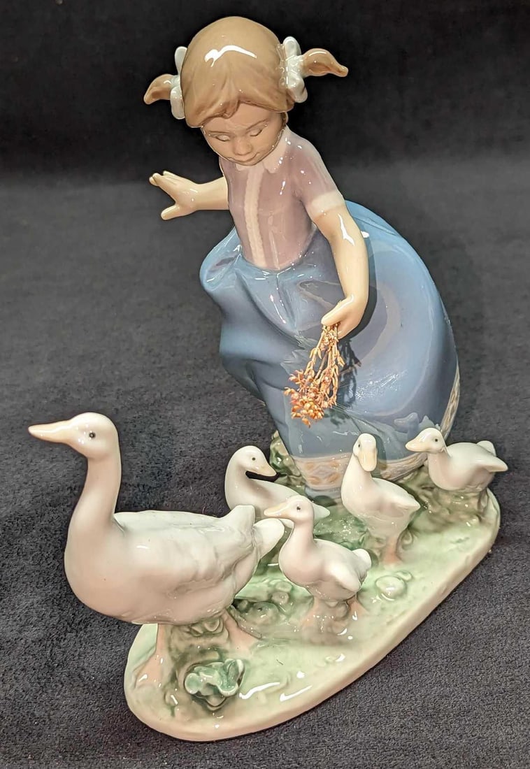 Retired Lladro Hurry Now Girl With Ducks Figurine: Retired Lladro Hurry Now Girl With Ducks Figurine. This was designed by Antonio Ramos and was released from the year 1988 to the year 1991. The figurine is approximately 6 1/2" x 4" x 7 3/8