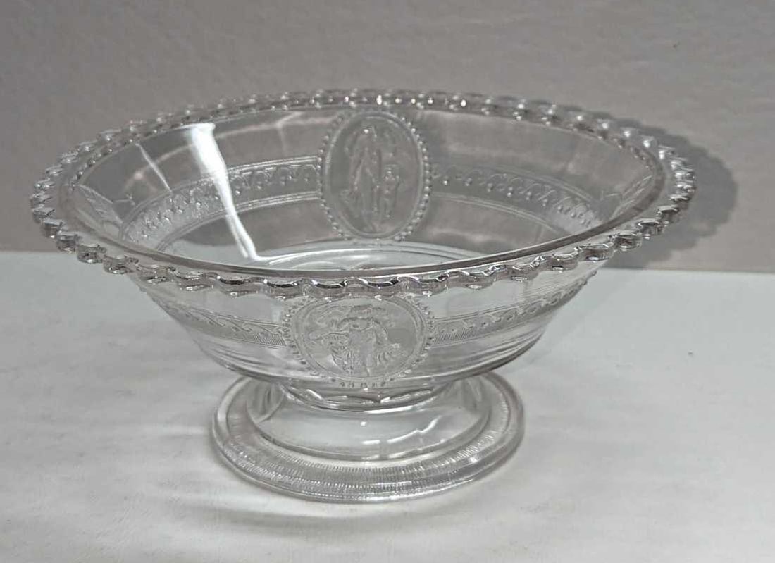 EAPG Venus And Cupid Large Round Footed Bowl: EAPG Venus And Cupid Large Round Footed Bowl. This is approximately 7 5/8" x 7 5/8" x 3 1/4" and it weighs 1.12lb. The bowl has some scratches, a small chip on the rim, and some white resi