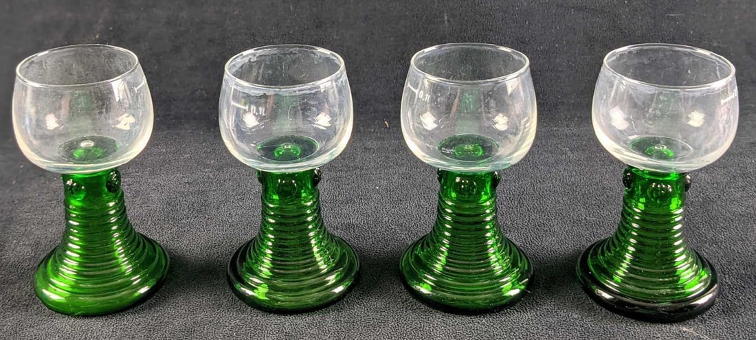 4 Vintage Ribbed Stem Wine Green Glasses: Four Vintage Ribbed Stem Wine Glasses. The maker and date of creation are unknown. Each glass is approx 2 3/4" x 2 2/4" x 4 3/4" and together they all weigh 1.61lb. The glasses are in a go