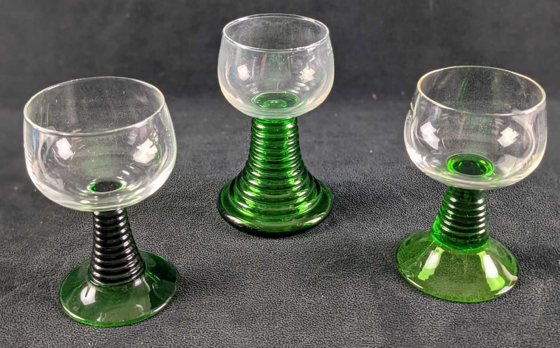 3 Vintage Ribbed Stem Wine Green Glasses: Three Vintage Ribbed Stem Wine Green Glasses. The maker and date of creation are unknown. The lot consists of: (1) Vintage Ribbed Stem Wine Green Glass. This is approx 3" x 3" x4 1/2". Has