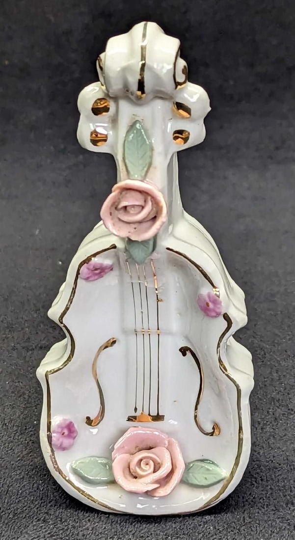 Vintage Bone China Violin Ring Holder Figurine: Vintage Bone China Violin Ring Holder Figurine. Can be used as a figurine, or lay it down and it can be used as a ring holder. This is approx 2" x 1 1/4" x 4 3/4" and it weighs 0.14lb. Has