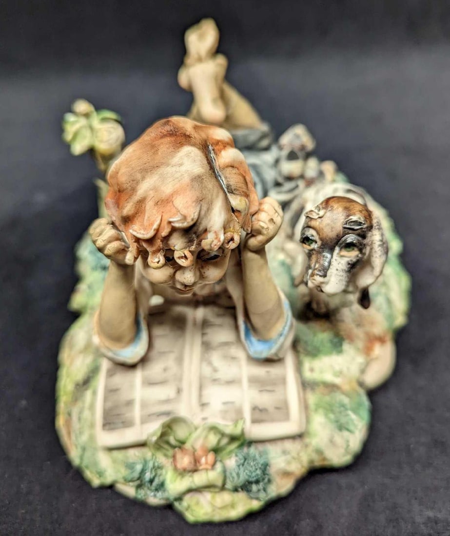 Capodimonte Figurine Milio Boy With Dog: Capodimonte Figurine Milio Boy With Dog. This figurine is approx 7 1/2" x 5" x 4 1/2" and it weighs 2.22 lbs. The figurine is in good, vintage condition with both the legs and arms were re