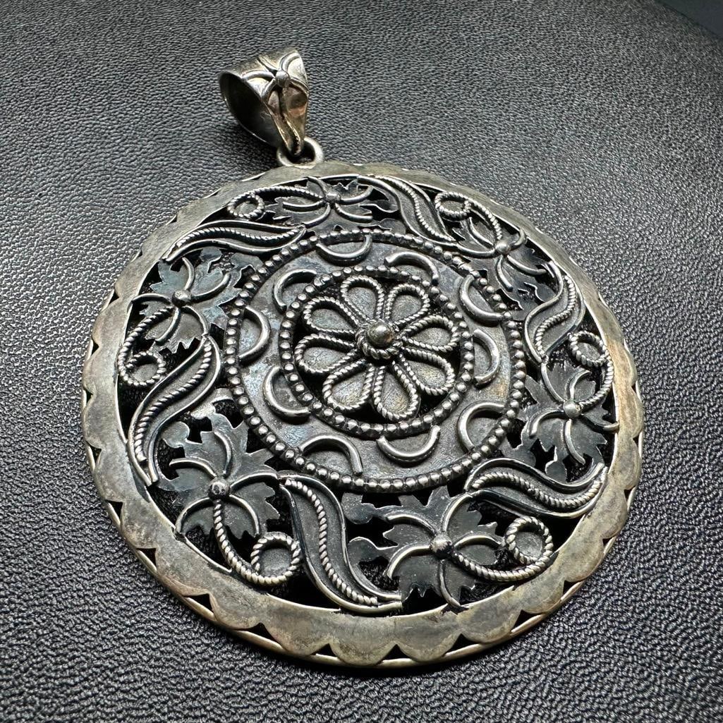 Sterling Silver 2.5" Round Pendant Floral Motif: This piece of jewelry has been tested and researched prior to listing. Please view all our pictures they are part of our description. DETAILS: Metal - Sterling Silver Color - Silver Stones - none Hall