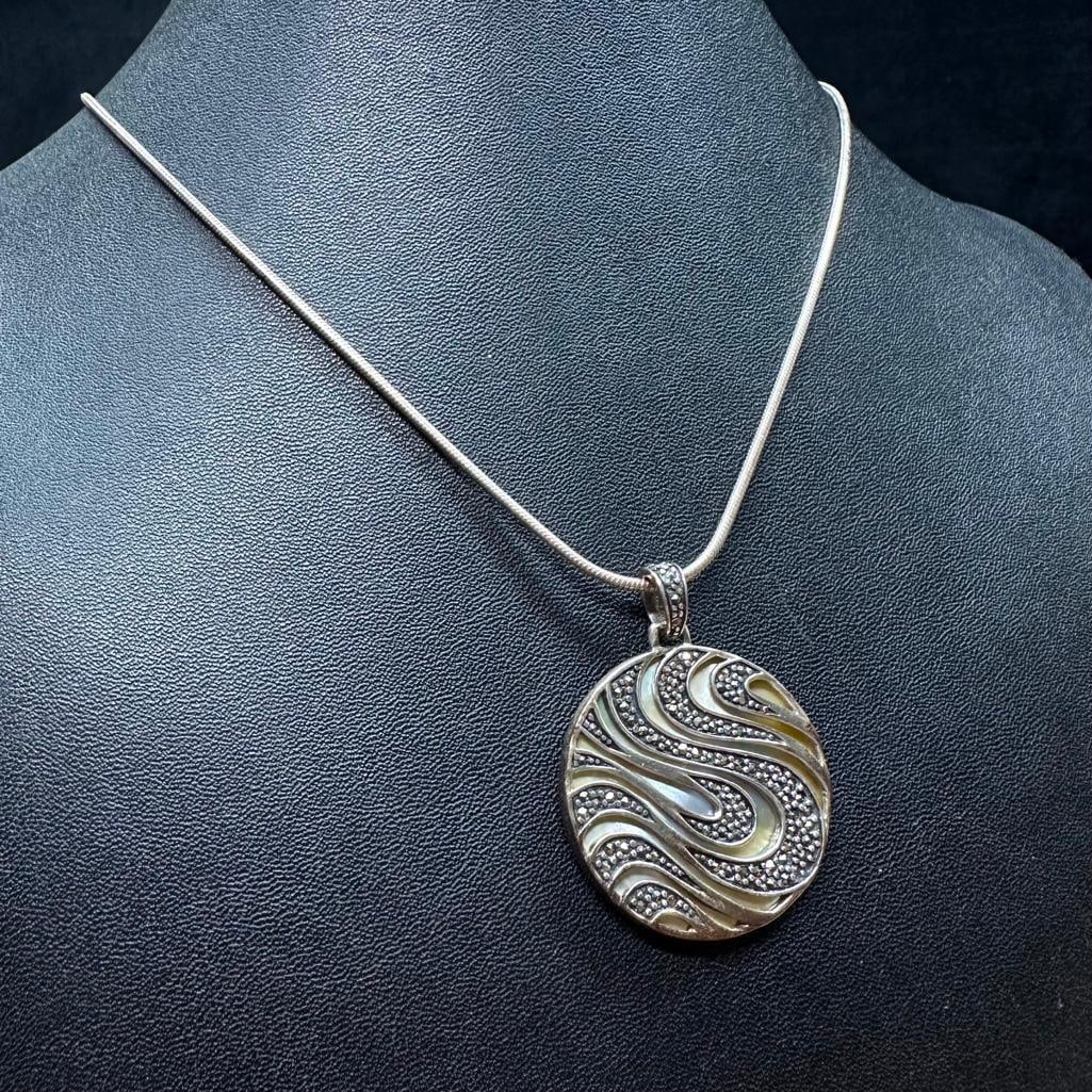 Sterling Silver Mother of Pearl Marcasite Pendant: This piece of jewelry has been tested and researched prior to listing. Please view all our pictures they are part of our description. DETAILS: Metal - Sterling Silver Color - Silver Stones - none Hall