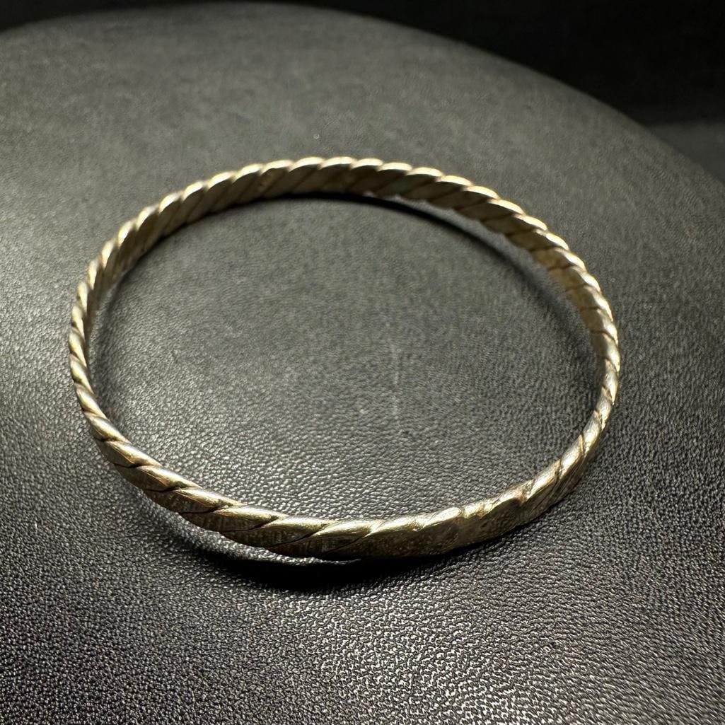 Sterling Silver Twist Bangle A: This piece of jewelry has been tested and researched prior to listing. Please view all our pictures they are part of our description. DETAILS: Metal - Sterling Silver Color - Silver Stones - none Hall